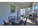 Outdoor patio with a dining set, grill, and a screened-in area, perfect for al fresco dining and entertaining at 1524 Flange Dr, Davenport, FL 33896
