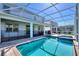 The screened-in pool and spa is a great place to relax after a long day; the brick patio completes the space at 1524 Flange Dr, Davenport, FL 33896