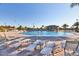Community pool with lounge chairs, umbrellas, and a bar area, creating a resort-style experience at 1524 Flange Dr, Davenport, FL 33896