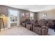 Inviting theater room with plush reclining chairs and natural light streaming through the windows, perfect for movie nights at 1524 Flange Dr, Davenport, FL 33896