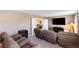 Spacious media room featuring comfortable seating, a large screen television, and ample space for entertainment at 1524 Flange Dr, Davenport, FL 33896