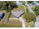 A high aerial view showing the home's yard and driveway at 16 General Doolittle Rd, Daytona Beach, FL 32124