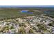 Aerial view of the property, showcasing the home's location and proximity to a lake and surrounding neighborhood at 16 General Doolittle Rd, Daytona Beach, FL 32124