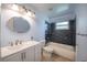 Bathroom with light blue walls with a tub, shower, toilet, and vanity at 16 General Doolittle Rd, Daytona Beach, FL 32124