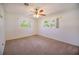 Bright bedroom with two windows and a ceiling fan at 16 General Doolittle Rd, Daytona Beach, FL 32124