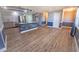 A view of the kitchen showing an island, wood floors, and stainless appliances at 16 General Doolittle Rd, Daytona Beach, FL 32124