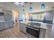 A kitchen featuring granite countertops, stainless appliances, and stylish pendant lighting at 16 General Doolittle Rd, Daytona Beach, FL 32124