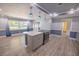 Open concept kitchen with gray cabinets, granite countertops, pendant lights and stainless steel appliances at 16 General Doolittle Rd, Daytona Beach, FL 32124