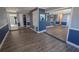 Spacious living area with hardwood flooring leading to the kitchen and hallways at 16 General Doolittle Rd, Daytona Beach, FL 32124