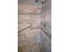 Modern shower with a pebble floor, grab bars and marbled tile surround at 16 General Doolittle Rd, Daytona Beach, FL 32124