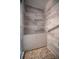 Shower stall showcasing neutral tile work, built-in bench, and pebble floor at 16 General Doolittle Rd, Daytona Beach, FL 32124