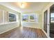 Bright sunroom with large windows and a glass door at 16 General Doolittle Rd, Daytona Beach, FL 32124