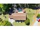 Aerial view showcasing the property's layout, including pool, garden, and ample green space at 16017 Harbar Oaks Dr, Montverde, FL 34756