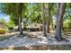 View of backyard featuring brick patio, storage shed and lush landscaping at 16017 Harbar Oaks Dr, Montverde, FL 34756