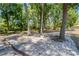 Private backyard patio surrounded by mature trees and natural beauty at 16017 Harbar Oaks Dr, Montverde, FL 34756