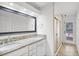 Bright bathroom featuring a double vanity with granite countertop and glass shower door leading to an outdoor area at 16017 Harbar Oaks Dr, Montverde, FL 34756