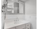 Bathroom features a white vanity with a white quartz countertop, decorative trim, and a large mirror at 16017 Harbar Oaks Dr, Montverde, FL 34756