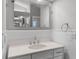 Bathroom features a white vanity with a white quartz countertop, decorative trim, and a large mirror at 16017 Harbar Oaks Dr, Montverde, FL 34756
