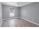 Bedroom featuring light gray walls, hardwood floors, and a window at 16017 Harbar Oaks Dr, Montverde, FL 34756