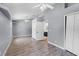 Bright bedroom featuring a high ceiling, double closets, wood-look floors, ceiling fans and light-gray walls at 16017 Harbar Oaks Dr, Montverde, FL 34756