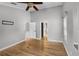 A spacious bedroom features vaulted ceilings, wood floors, ceiling fan, and multiple doors leading to other rooms at 16017 Harbar Oaks Dr, Montverde, FL 34756