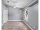Neutral bedroom featuring a high ceiling, double closet, ceiling fan, light gray walls and wood-look floors at 16017 Harbar Oaks Dr, Montverde, FL 34756