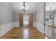 Formal dining area featuring hardwood floors, elegant lighting, and classic wainscoting at 16017 Harbar Oaks Dr, Montverde, FL 34756
