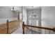 Bright foyer featuring hardwood floors, staircase, and an elegant chandelier at 16017 Harbar Oaks Dr, Montverde, FL 34756