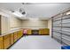 Spacious garage with updated door, built-in work bench, and ample storage space at 16017 Harbar Oaks Dr, Montverde, FL 34756
