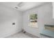 Utility room with a window, sink, and hookups for a washer and dryer at 16017 Harbar Oaks Dr, Montverde, FL 34756