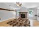 Cozy living room with a brick fireplace, hardwood floors, and ample natural light at 16017 Harbar Oaks Dr, Montverde, FL 34756