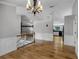 Open-concept living space with hardwood floors, wainscoting and great flow to kitchen at 16017 Harbar Oaks Dr, Montverde, FL 34756