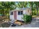 Charming shed featuring a unique design, offering extra storage space or potential for a workshop at 16017 Harbar Oaks Dr, Montverde, FL 34756