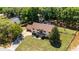 Aerial view of the home featuring large trees, back patio, and a large front lawn at 16017 Harbar Oaks Dr, Montverde, FL 34756