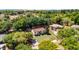 Aerial shot of a lovely home on a large lot with mature trees and meticulously maintained landscaping at 16017 Harbar Oaks Dr, Montverde, FL 34756
