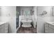 Bright bathroom features wood floors, a freestanding tub, wainscoting, and a glass-enclosed shower at 16017 Harbar Oaks Dr, Montverde, FL 34756