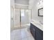 Bright bathroom features tiled floors and a glass enclosed shower with a white vanity at 16017 Harbar Oaks Dr, Montverde, FL 34756