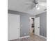Neutral toned bedroom with hard wood flooring, neutral walls and access to the kitchen at 16017 Harbar Oaks Dr, Montverde, FL 34756