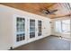 Cozy covered patio featuring wood ceiling, fan, and view of pool, inviting outdoor relaxation at 16017 Harbar Oaks Dr, Montverde, FL 34756