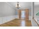 Bright dining room with hardwood floors, wainscoting, and a window with curtains at 16017 Harbar Oaks Dr, Montverde, FL 34756