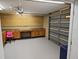 Large garage with storage, cabinets, pegboard and space for a workbench at 16017 Harbor Oaks Dr, Montverde, FL 34756