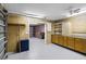 Large garage with cabinets, shelving, a pink accent chair, and a multi-car garage door at 16017 Harbar Oaks Dr, Montverde, FL 34756