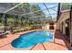 Screened in pool with an attached jacuzzi spa is surrounded by a brick paver deck at 16017 Harbar Oaks Dr, Montverde, FL 34756