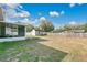 Large backyard featuring a storage shed, wooden fence, and room for outdoor activities at 1606 S Center St, Eustis, FL 32726