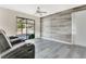 Inviting living room boasts modern wood floors, a door to the outside and wood accent wall at 1606 S Center St, Eustis, FL 32726