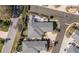 Aerial view of a home with a patio, meticulous landscaping, and a circular driveway at 16800 Se 80Th Bathurst Ct, The Villages, FL 32162