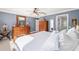 Comfortable bedroom boasts a wooden dresser, ceiling fan, and bright natural light at 16800 Se 80Th Bathurst Ct, The Villages, FL 32162