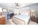 Bedroom featuring a ceiling fan, a neutral carpet and an attached bath at 16800 Se 80Th Bathurst Ct, The Villages, FL 32162
