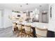 Modern kitchen featuring stainless steel appliances, white cabinets, quartz countertops and bar seating at 16800 Se 80Th Bathurst Ct, The Villages, FL 32162