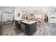 Open-concept kitchen with stainless steel appliances and a view into the cozy Gathering room at 16800 Se 80Th Bathurst Ct, The Villages, FL 32162